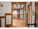 Inviting living room featuring hardwood floors, beamed ceilings, fireplace, and classic wood trim at 1317 Birch St, Denver, CO 80220