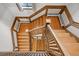 Top-down view of a wooden staircase with a distinctive landing, decorative walls, and natural light at 1317 Birch St, Denver, CO 80220