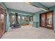 Sunroom features a unique fireplace, outdoor access, and a brick accent wall at 1317 Birch St, Denver, CO 80220
