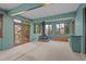 Bright sunroom features a striking central fireplace and outdoor access at 1317 Birch St, Denver, CO 80220
