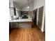Open kitchen features stainless steel appliances, granite countertops, and hardwood floors at 7863 S Harrison Cir, Centennial, CO 80122