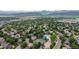 An aerial view highlights neighborhood amenities with a pool and tennis courts nestled among tree-lined streets at 7176 S Pierson St, Littleton, CO 80127