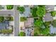 An aerial view of the home shows a landscaped yard in a neighborhood with mature trees at 7176 S Pierson St, Littleton, CO 80127