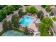 Aerial view features a community pool, playground, and tennis courts, surrounded by mature trees and neighborhood streets at 7176 S Pierson St, Littleton, CO 80127