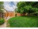 The backyard features a lush lawn and a wooden fence, providing privacy and a great space for outdoor activities at 7176 S Pierson St, Littleton, CO 80127