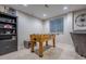 Finished basement featuring a foosball table and a built-in bookcase at 7176 S Pierson St, Littleton, CO 80127