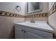 Powder room featuring a white vanity with modern fixtures and decorative tile accents at 7176 S Pierson St, Littleton, CO 80127