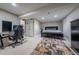 A basement bedroom with dark wood furniture, a gaming setup and plush carpet flooring under recessed lighting at 7176 S Pierson St, Littleton, CO 80127