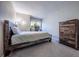 Comfortable bedroom with wooden bed frame, dresser, and window at 7176 S Pierson St, Littleton, CO 80127