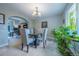 Formal dining room featuring a chandelier, stylish table set, and ample natural light at 7176 S Pierson St, Littleton, CO 80127