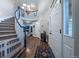 Grand entryway featuring a staircase, wood floors, a chandelier, and a view into the living spaces at 7176 S Pierson St, Littleton, CO 80127