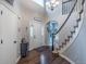 Inviting foyer showcases hardwood flooring, staircase, chandelier, and natural light from the front door at 7176 S Pierson St, Littleton, CO 80127