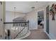 Second-floor hallway featuring a decorative railing, neutral paint, and access to bedrooms at 7176 S Pierson St, Littleton, CO 80127