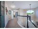 Upstairs hallway with carpet and decorative railings, providing access to different rooms at 7176 S Pierson St, Littleton, CO 80127