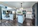 Modern kitchen with stainless steel appliances, granite countertops, an island, and open layout for easy entertaining at 7176 S Pierson St, Littleton, CO 80127