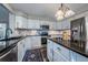 Updated kitchen featuring stainless steel appliances, granite countertops, and stylish cabinetry, offering functionality and style at 7176 S Pierson St, Littleton, CO 80127