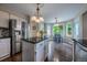 Bright kitchen showcases stainless steel appliances, granite countertops, and an island with breakfast bar seating at 7176 S Pierson St, Littleton, CO 80127