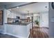 Open-concept kitchen featuring stainless steel appliances, granite countertops, and modern cabinetry, perfect for cooking at 7176 S Pierson St, Littleton, CO 80127