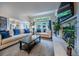 Inviting living room featuring a stone fireplace, open windows, and comfortable seating for relaxing or entertaining at 7176 S Pierson St, Littleton, CO 80127