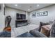 A cozy living room features a large TV, fireplace, and comfortable seating with stylish decor and neutral walls at 7176 S Pierson St, Littleton, CO 80127