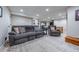 Open living area with plush reclining sofa and chair on top of a patterned carpet and recessed ceiling lights at 7176 S Pierson St, Littleton, CO 80127
