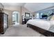 Comfortable main bedroom featuring an ensuite bathroom and a view of the outdoors at 7176 S Pierson St, Littleton, CO 80127