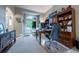 Well-lit home office with built-in shelving, a large desk, and a comfortable seating area by the window at 7176 S Pierson St, Littleton, CO 80127