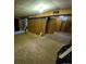 View of the partially finished basement showcasing wood paneling and old carpeting at 12058 E Virginia Pl, Aurora, CO 80012