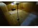 View of the partially finished basement showcasing wood paneling, old carpeting, and unique lamp at 12058 E Virginia Pl, Aurora, CO 80012