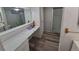 Bathroom featuring updated vanity, flooring and a glass-enclosed shower at 12058 E Virginia Pl, Aurora, CO 80012