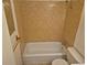 Full bathroom with tile walls, shower-tub combo, and modern fixtures at 12058 E Virginia Pl, Aurora, CO 80012