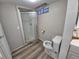 Bathroom featuring a toilet and a glass-enclosed shower stall at 12058 E Virginia Pl, Aurora, CO 80012