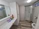 Bathroom featuring an updated vanity, flooring and a glass-enclosed shower stall at 12058 E Virginia Pl, Aurora, CO 80012