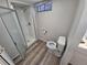 A bathroom with a stand up shower and toilet in a small space at 12058 E Virginia Pl, Aurora, CO 80012