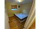 Bedroom with hardwood floors, bed, and window at 12058 E Virginia Pl, Aurora, CO 80012