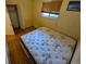 Small bedroom features hardwood floors and a window at 12058 E Virginia Pl, Aurora, CO 80012