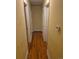 Neutral-toned hallway with wood flooring and white door frames at 12058 E Virginia Pl, Aurora, CO 80012