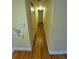 Hallway featuring hardwood floors and neutral-colored walls at 12058 E Virginia Pl, Aurora, CO 80012