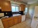Functional kitchen with a bright window, double sink, dishwasher, and ample counter space at 12058 E Virginia Pl, Aurora, CO 80012