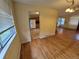 Open-concept living space with hardwood floors, and a view into the kitchen at 12058 E Virginia Pl, Aurora, CO 80012