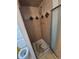 Small shower stall with decorative tile at 12058 E Virginia Pl, Aurora, CO 80012