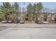 Brick townhome featuring mature trees and an abundance of parking for residents and guests at 324 Wright St # 304, Lakewood, CO 80228
