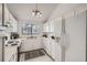 Well-maintained kitchen with white appliances, ample cabinet space, and a bright window at 324 Wright St # 304, Lakewood, CO 80228