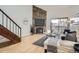 Inviting living room with stone fireplace, wood floors, and large windows offering plenty of natural light at 324 Wright St # 304, Lakewood, CO 80228