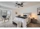Comfortable bedroom with neutral carpet, ceiling fan, window with exterior view, bench and side tables at 324 Wright St # 304, Lakewood, CO 80228