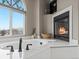 Bright bathroom featuring a jacuzzi tub, modern shower, stained glass window, and fireplace at 15652 W 79Th Pl, Arvada, CO 80007