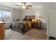 This beautiful bedroom offers a ceiling fan and natural wood furniture, including a rustic style bed at 15652 W 79Th Pl, Arvada, CO 80007