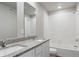 Bright bathroom featuring granite double vanity and shower over tub at 7322 Green River Ave, Frederick, CO 80530