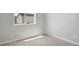 A sunlit bedroom with neutral carpeting, a large window, and ample space for furniture at 7322 Green River Ave, Frederick, CO 80530