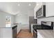 Modern kitchen featuring stainless steel appliances, granite countertops, and an open layout at 7322 Green River Ave, Frederick, CO 80530